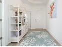 Bright entryway with a white shelf, decorative rug, and modern decor at 11717 74Th E Cir, Palmetto, FL 34221