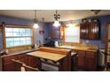 Kitchen featuring custom cabinetry, matching countertops, and a spacious kitchen island at 1207 Pine Nw Ave, Largo, FL 33770