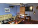 Comfortable living room features a decorative fish and sailboat painting on the wall at 1207 Pine Nw Ave, Largo, FL 33770