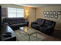 Cozy living room with modern furniture, neutral walls and carpet, and bright window light at 12413 Oak Cedar Pl # 201, Tampa, FL 33612