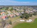 An aerial view of a beautiful home near a golf course, showing a neighboring pool at 13854 Thoroughbred Dr, Dade City, FL 33525