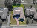 An overhead view of a lovely home, with a view of a golf course in the background at 13854 Thoroughbred Dr, Dade City, FL 33525