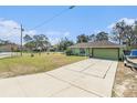 Long driveway leading to the home, showcasing its well-kept lawn and mature trees at 2259 Renton Ln, Spring Hill, FL 34609