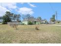Expansive front yard with a view of the home, driveway, and surrounding greenery at 2259 Renton Ln, Spring Hill, FL 34609