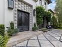 Close-up of elegant double doors with decorative tile and lush greenery, enhancing curb appeal at 2603 W Parkland Blvd, Tampa, FL 33609