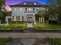 Elegant two-story home showcasing a beautifully landscaped front yard with a stone wall and charming double doors at 2603 W Parkland Blvd, Tampa, FL 33609