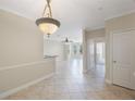 Spacious living room featuring light tile floors, neutral walls and decorative lighting fixture at 2747 Via Capri # 1122, Clearwater, FL 33764