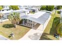 Aerial view of single-story home featuring carport, palm tree and neat landscaping at 5238 Vera St, Zephyrhills, FL 33542
