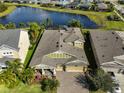 Aerial view of the house with well-maintained landscaping, screened in pool, and stunning water view at 7328 Paradiso Dr, Apollo Beach, FL 33572