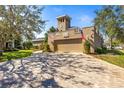 Exterior shot of the garage with long driveway at 7425 Terrace River Dr, Temple Terrace, FL 33637