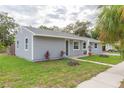 Attractive gray home with a neatly landscaped front yard at 800 51St S St, Gulfport, FL 33707