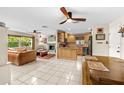 Open concept living room and kitchen with wood cabinets, modern appliances, and tile flooring at 8083 Bayhaven Dr, Seminole, FL 33776