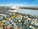 An aerial view shows a waterfront house with a private dock, swimming pool, and attractive landscaping at 1029 Bal Harbour Dr, Apollo Beach, FL 33572