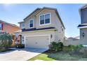 Two-story home with an attached two-car garage, a driveway and a well-maintained lawn at 11117 Abaco Island Ave, Riverview, FL 33579