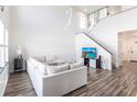 Bright living room boasting high ceilings, hardwood floors, contemporary furnishings, and a staircase leading to the second floor at 11539 Tangle Branch Ln, Gibsonton, FL 33534