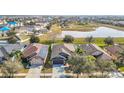 Aerial view showcasing home's roof, landscaping, and neighborhood pond in a Gathering-friendly community at 12222 Legacy Bright St, Riverview, FL 33578