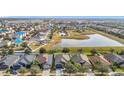 Community aerial showcasing the neighborhood layout, nearby pond, and the arrangement of homes at 12222 Legacy Bright St, Riverview, FL 33578