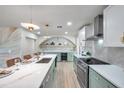 Well-lit kitchen boasting white countertops, stainless steel appliances, stylish lighting, and a center island with seating at 13330 88Th Pl, Seminole, FL 33776