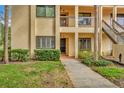 Close up of a charming condo showcasing a well maintained landscape and welcoming front door at 1801 E Lake Rd # 11A, Palm Harbor, FL 34685