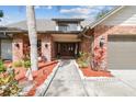 Close up of the home's charming entrance and the attached two car garage at 1902 Sweet Bay Ct, Plant City, FL 33566