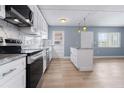 Updated kitchen featuring stainless steel appliances, white cabinets and marble countertops at 2 N Fernwood Ave # 33, Clearwater, FL 33765