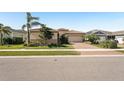 Charming home boasting well-maintained landscaping and a brick driveway leading to a spacious two-car garage at 20237 Bandera Pl, Venice, FL 34293