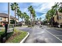 Gated community entrance with lush greenery and a grand entrance, providing privacy and security for residents at 2171 Portofino Place # 27-2725, Palm Harbor, FL 34682