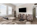 Bright living room features wood floors, plantation shutters, and a decorative console at 21826 Pineywood Loop, Land O Lakes, FL 34639