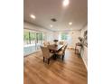 Bright dining area with sliding door access to the screened in patio at 2488 Orangepointe Ave, Palm Harbor, FL 34683