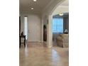 Elegant foyer with tile flooring, arched doorway, and a view into the inviting living spaces at 3205 Majestic View Dr, Lutz, FL 33558