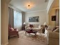 Cozy living room featuring comfortable seating, soft lighting, and a decorative area rug at 3205 Majestic View Dr, Lutz, FL 33558