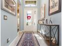 Bright entryway featuring tile flooring, a console table, and an overhead transom window at 4920 Sevilla Shores Dr, Wimauma, FL 33598
