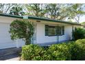 Close-up of a well-maintained home featuring decorative shutters and a freshly painted facade at 4964 Huntington Ne St, St Petersburg, FL 33703