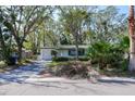 Quaint single-story home featuring a manicured front lawn and a cozy, inviting curb appeal at 4964 Huntington Ne St, St Petersburg, FL 33703