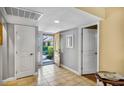 Bright entryway featuring tiled floors, coat closet, and a view to the front yard at 707 Old Mill Pond Rd, Palm Harbor, FL 34683