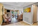 Comfortable living room with a stone fireplace, hardwood floors, and plenty of natural light at 707 Old Mill Pond Rd, Palm Harbor, FL 34683