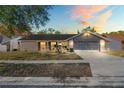 Charming single-story home with a well-maintained lawn, inviting front porch, and attached two-car garage at 8204 Reynolds Dr, Hudson, FL 34667