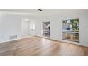 Bright living room features new laminate flooring, fresh neutral paint, and an abundance of natural light at 8204 Reynolds Dr, Hudson, FL 34667