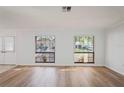 Bright living room features new laminate flooring, fresh neutral paint, and an abundance of natural light at 8204 Reynolds Dr, Hudson, FL 34667