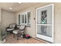 Inviting entryway featuring tiled flooring, comfortable seating, and a decorative glass accent door at 9201 Lunar Ln, Port Richey, FL 34668