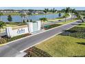 Landscaped entrance to Isles at Bayview featuring water feature, manicured landscaping and a view of the lake at 11751 Moonsail Dr, Parrish, FL 34219