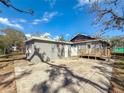 View of the backyard featuring a detached garage and wooden patio at 2111 26Th S St, St Petersburg, FL 33712