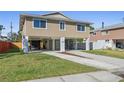 Charming elevated home shows a two-car drive and a well manicured lawn at 227 84Th Ne Ave, St Petersburg, FL 33702