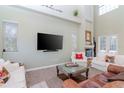 Bright living room with high ceilings, fireplace, large TV, and comfortable white and brown sofas at 320 Georgia Ave, Crystal Beach, FL 34681