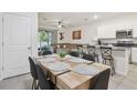 Open-concept dining area with contemporary table, chairs and views of the living room and kitchen at 3313 Pleasant Willow Ct, Brandon, FL 33511