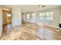 Open-concept living area featuring hardwood floors, natural light, and a view of the entryway at 3902 W Iowa Ave, Tampa, FL 33616