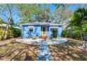 Charming single-story blue home with a walkway and a landscaped front yard at 4921 24Th S Ave, Gulfport, FL 33707