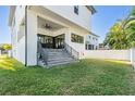 Backyard featuring concrete stairs leading to the covered patio and a freshly cut lawn at 619 Danube Ave, Tampa, FL 33606