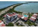 Aerial view of Isla del Sol condo with community pool, dock, Tampa Bay, and parking at 6365 Bahia Del Mar Blvd # 112, St Petersburg, FL 33715