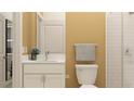 Well-lit bathroom with white cabinets, granite countertop, gray towel, toilet, mirror, and tiled shower at 6866 E 115Th St, Palmetto, FL 34221